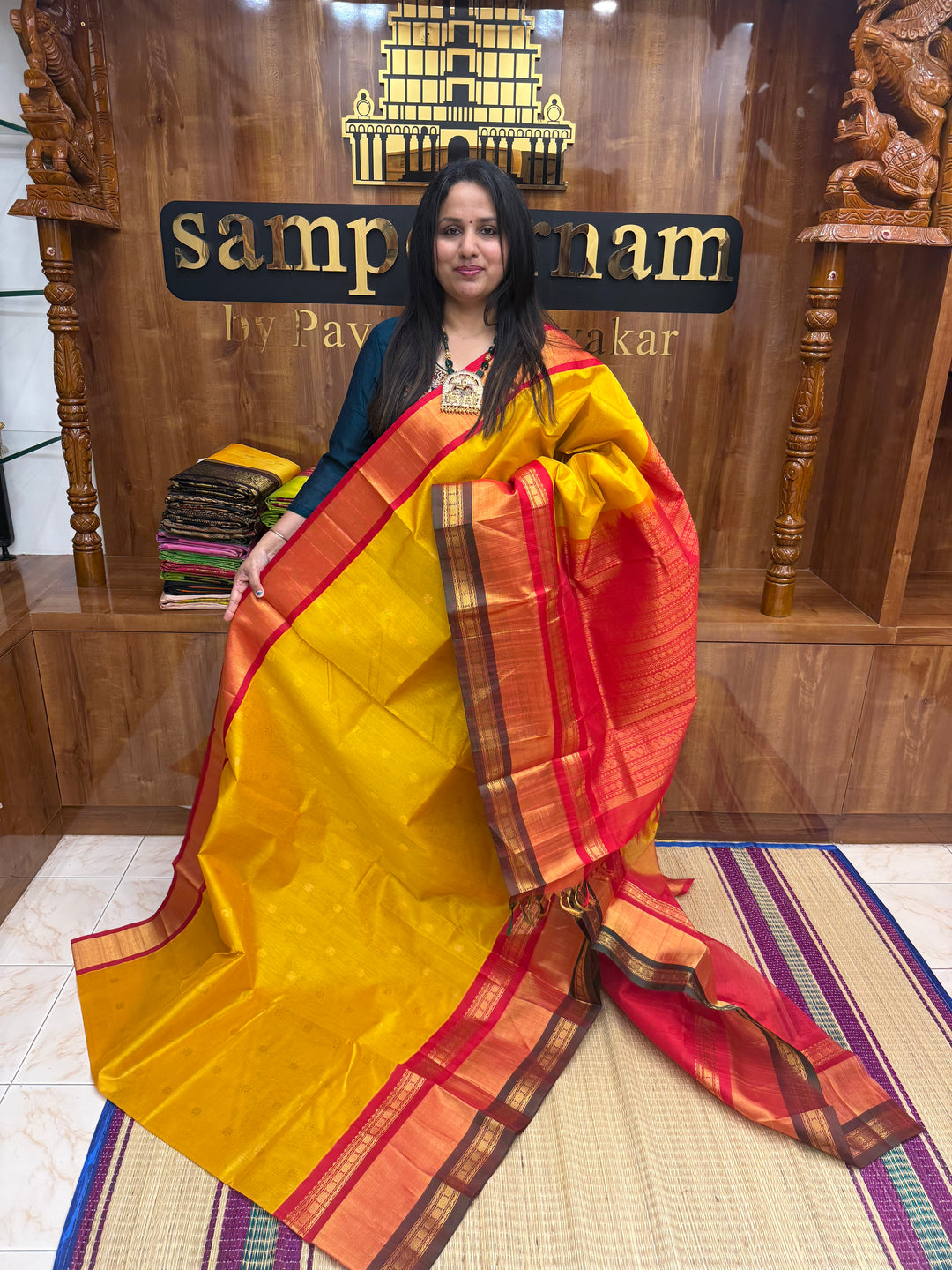 Manjal with Red , rich Floral Zari butta in the body  and One side Triple  Borders , rich Pallu Korvai Silk Cotton Saree