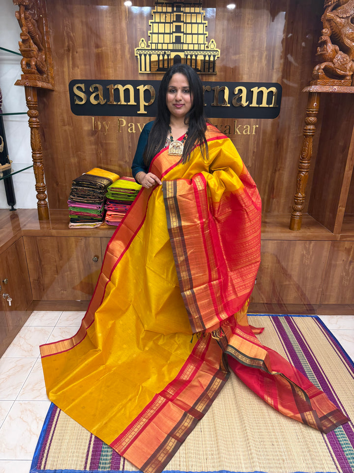 Manjal with Red , rich Floral Zari butta in the body  and One side Triple  Borders , rich Pallu Korvai Silk Cotton Saree