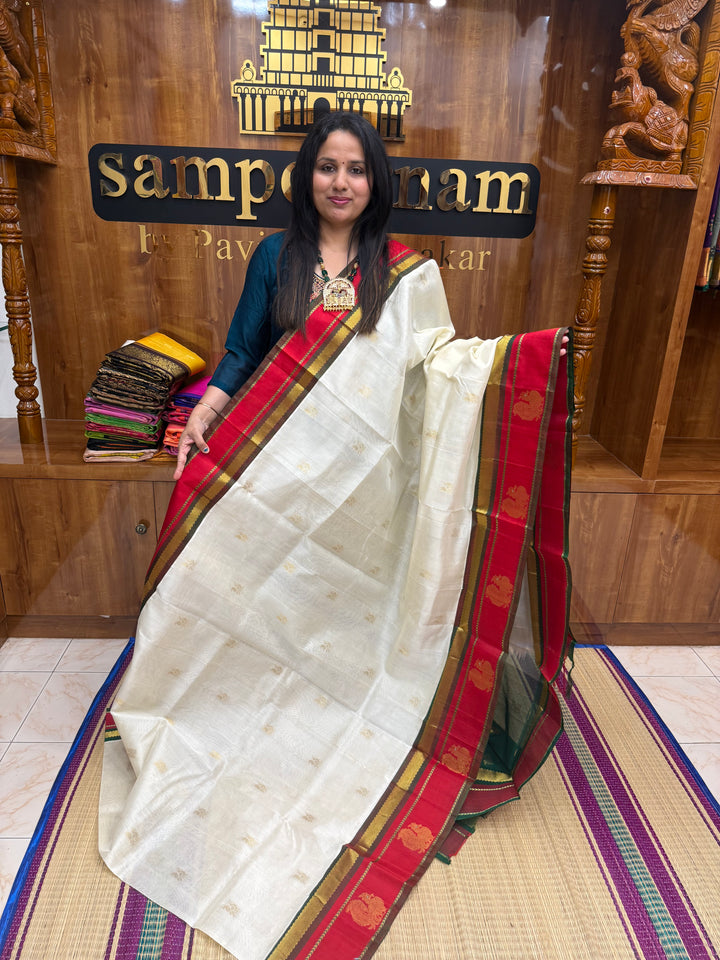 Offwhite with Green ,  rich Annam  Zari butta in the body  and  Annam  Borders , rich Pallu Korvai Silk Cotton Saree