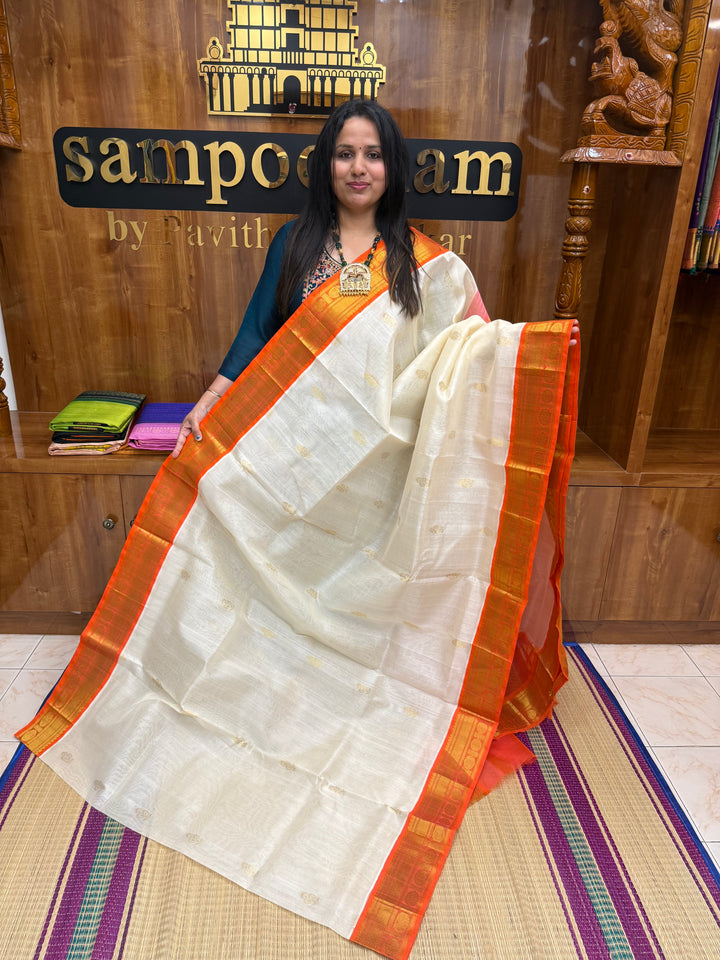 Offwhite with Orange , rich Floral Zari butta in the body and Traditional Borders , rich Pallu Korvai Silk Cotton Saree