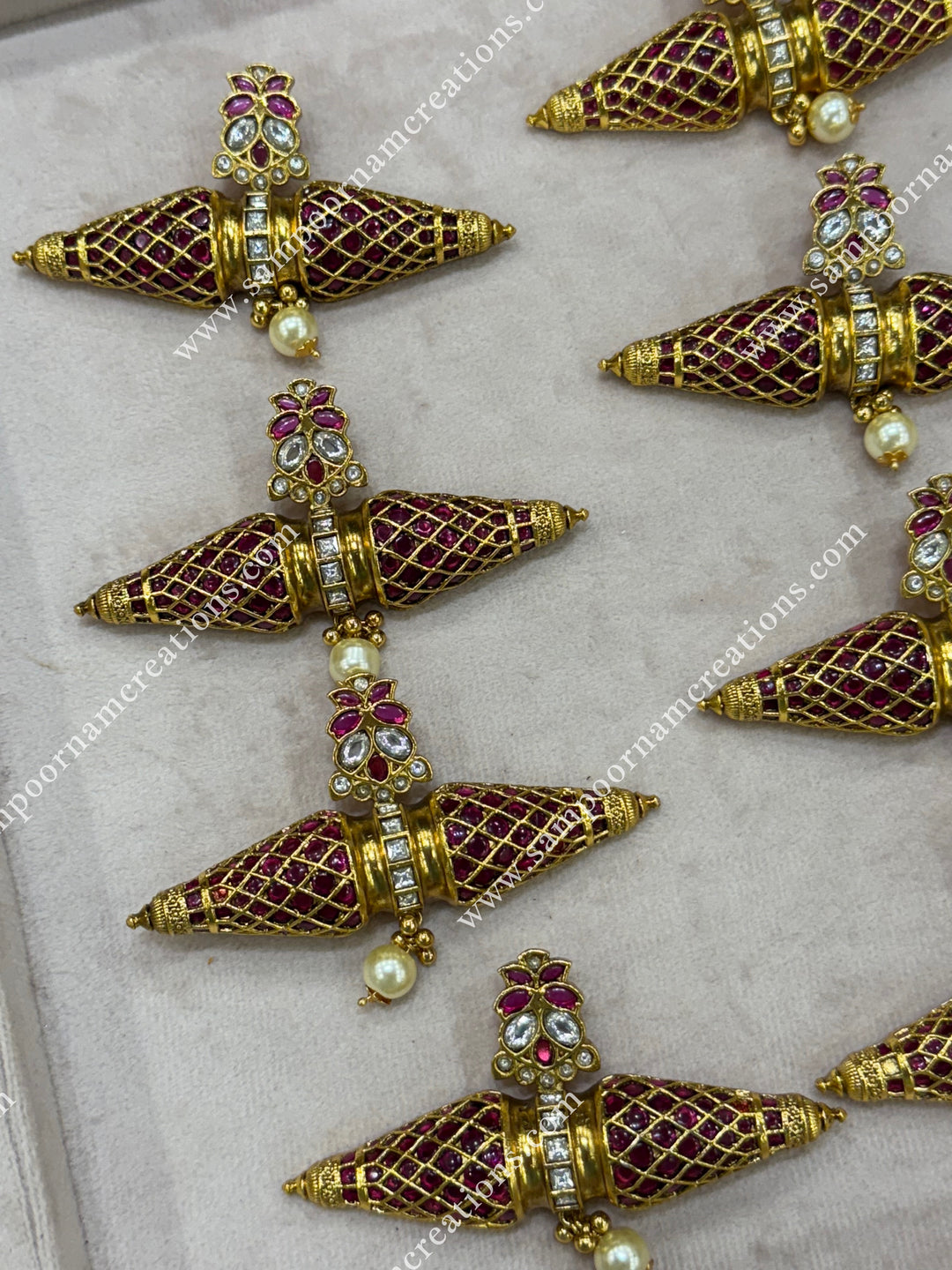 This heritage inspired necklace features a striking two cone shaped pendant adorned with rich red stones and shimmering white stones — a timeless design rooted in South Indian elegance