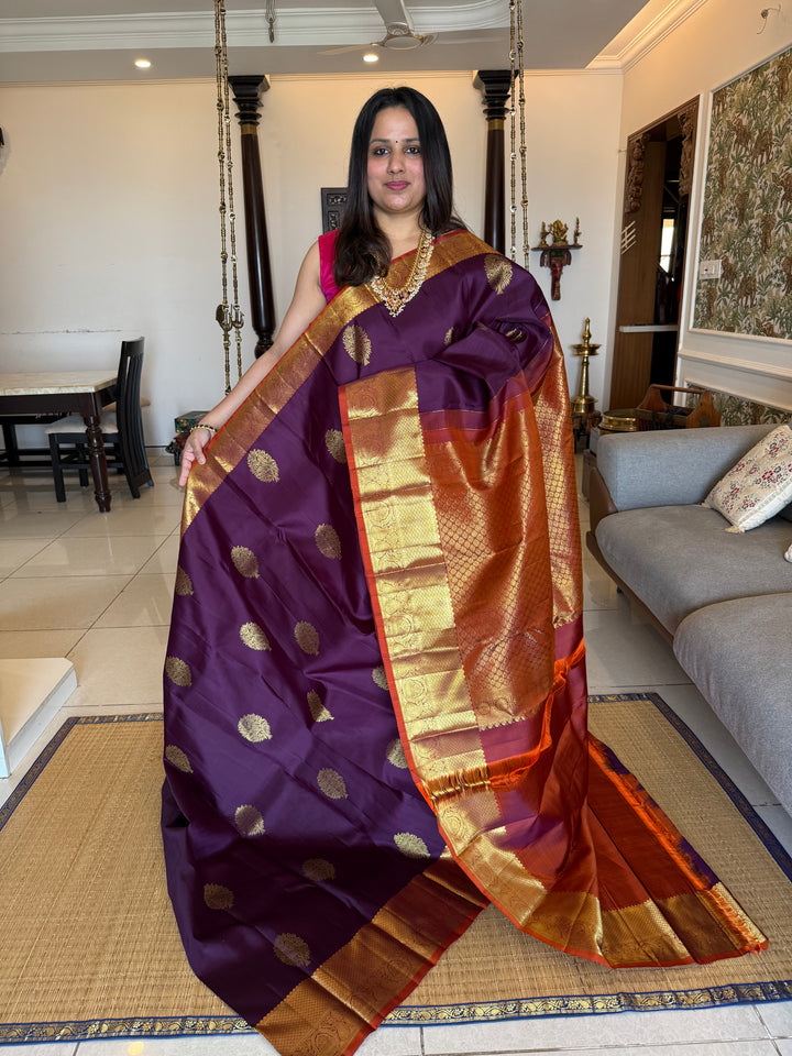 A Classic Navalpazham Jamun with Rust Orange Colour Saree with Rich Floral Zari Motif in the Body and Traditional Rich Border and Pallu Pure Kanjivaram Silk Saree