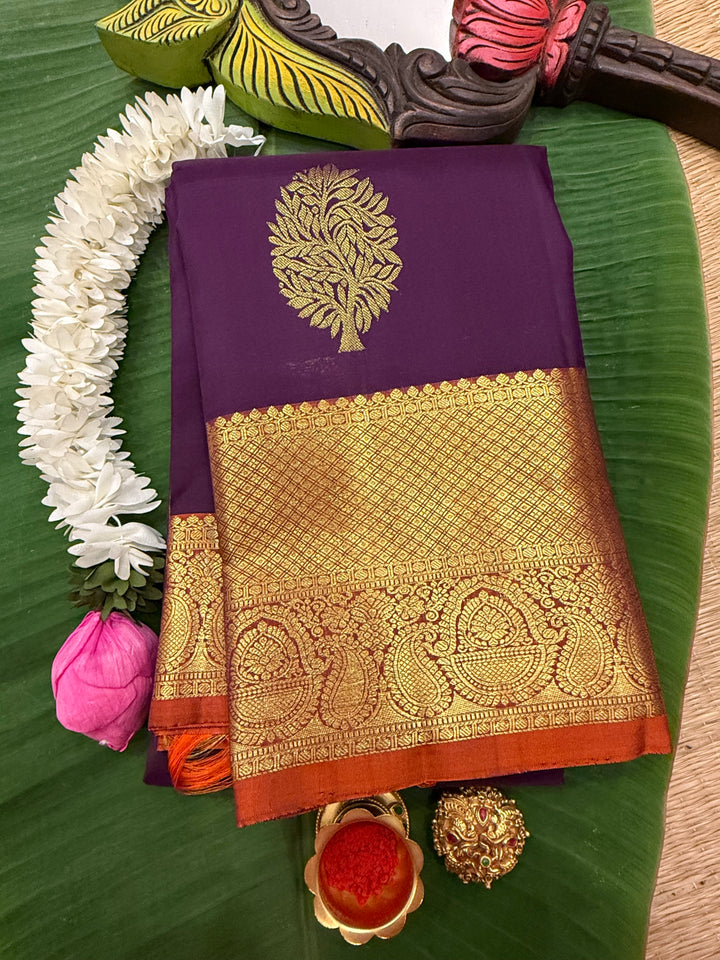 A Classic Navalpazham Jamun with Rust Orange Colour Saree with Rich Floral Zari Motif in the Body and Traditional Rich Border and Pallu Pure Kanjivaram Silk Saree
