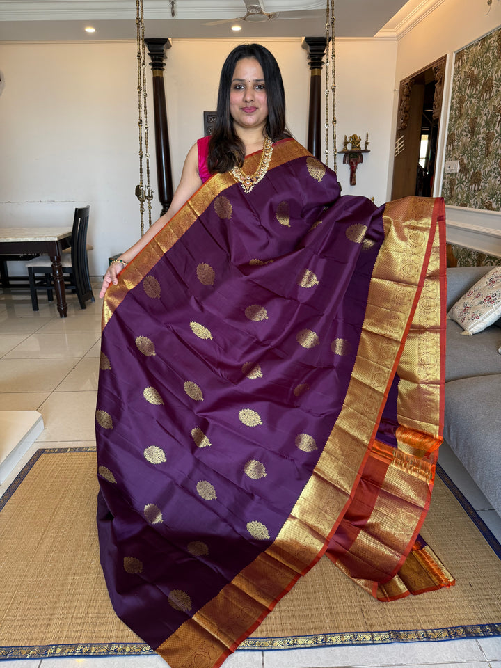 A Classic Navalpazham Jamun with Rust Orange Colour Saree with Rich Floral Zari Motif in the Body and Traditional Rich Border and Pallu Pure Kanjivaram Silk Saree