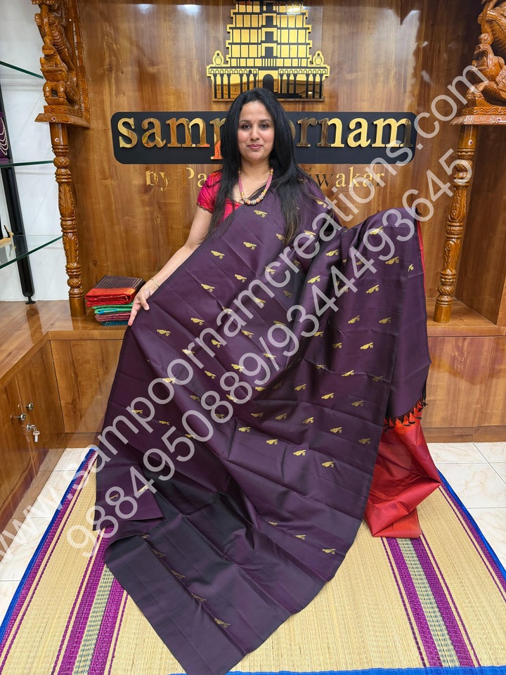 Dark Jamun with Rust Orange , Rich Parrot Zari  butta in the body  and  a Rich Pallu , Pure Kanjivaram Silk Saree