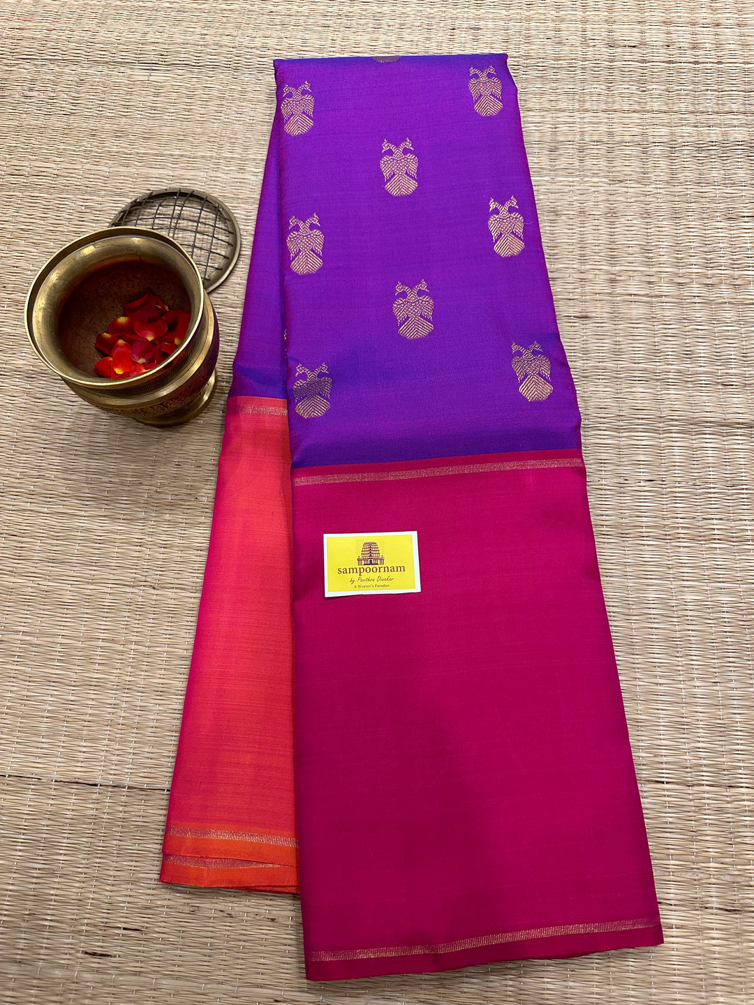 A Classic Mubbagam in Purple Orange and Magenta Shade with the Gandaberundu Zari motif in the Body and Rich Kili Motif in the Pallu Pure Kanjivaram Silk Saree