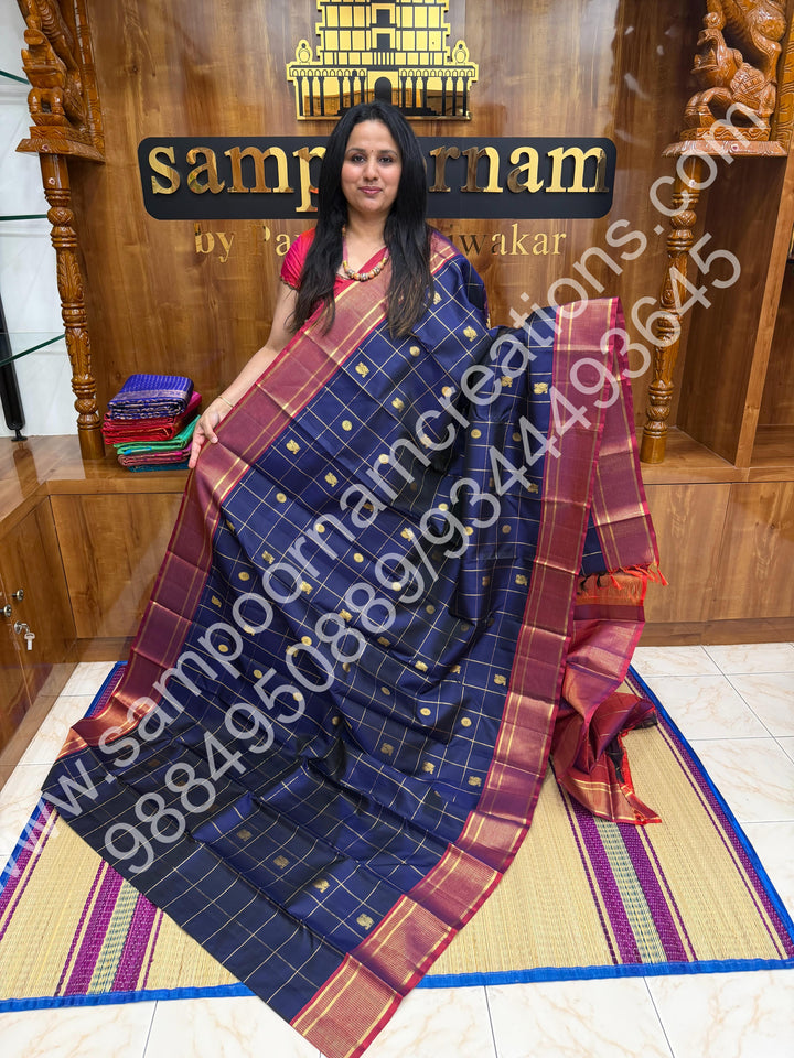 Dark Blue with Mauve , Rich Mayil and Chakram  butta in the body with Zari checks , Traditional borders and Rich Pallu , Pure Kanjivaram Silk Saree