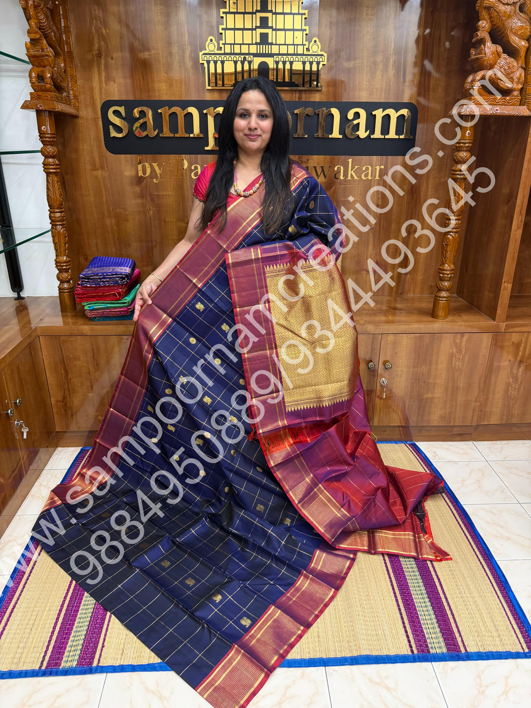 Dark Blue with Mauve , Rich Mayil and Chakram  butta in the body with Zari checks , Traditional borders and Rich Pallu , Pure Kanjivaram Silk Saree