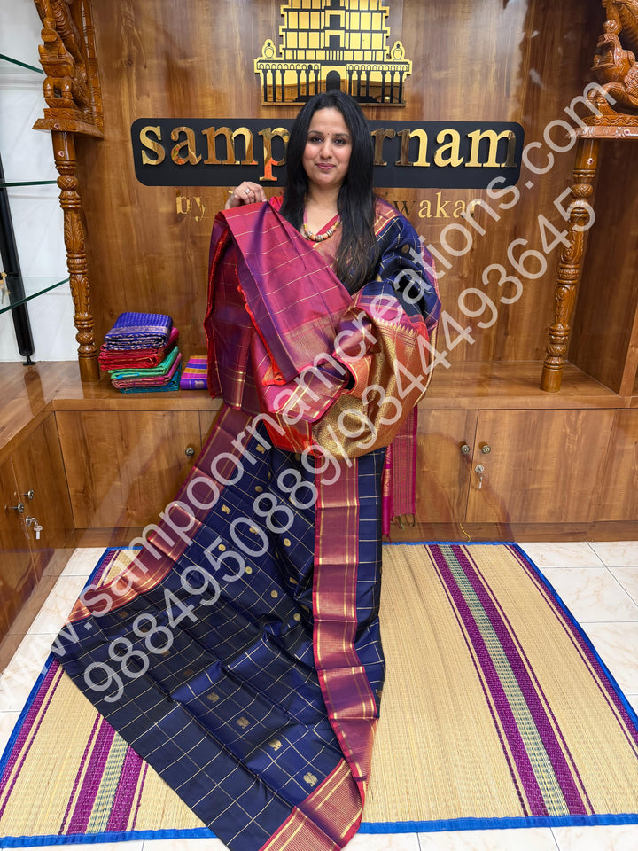 Dark Blue with Mauve , Rich Mayil and Chakram  butta in the body with Zari checks , Traditional borders and Rich Pallu , Pure Kanjivaram Silk Saree