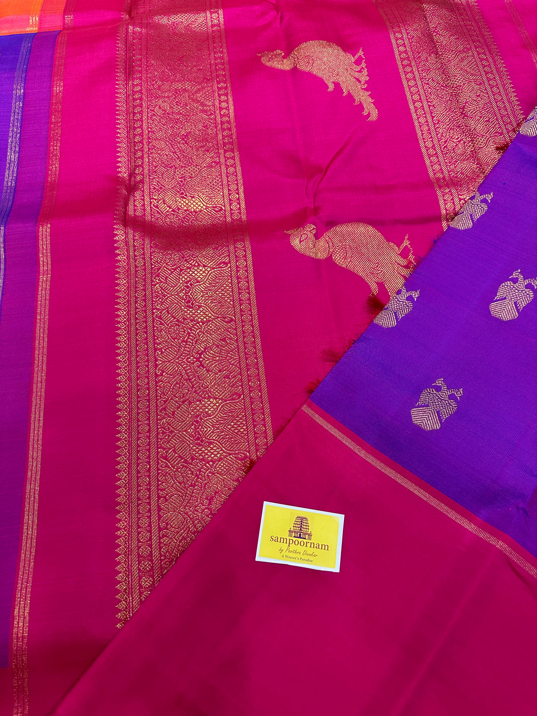 A Classic Mubbagam in Purple Orange and Magenta Shade with the Gandaberundu Zari motif in the Body and Rich Kili Motif in the Pallu Pure Kanjivaram Silk Saree