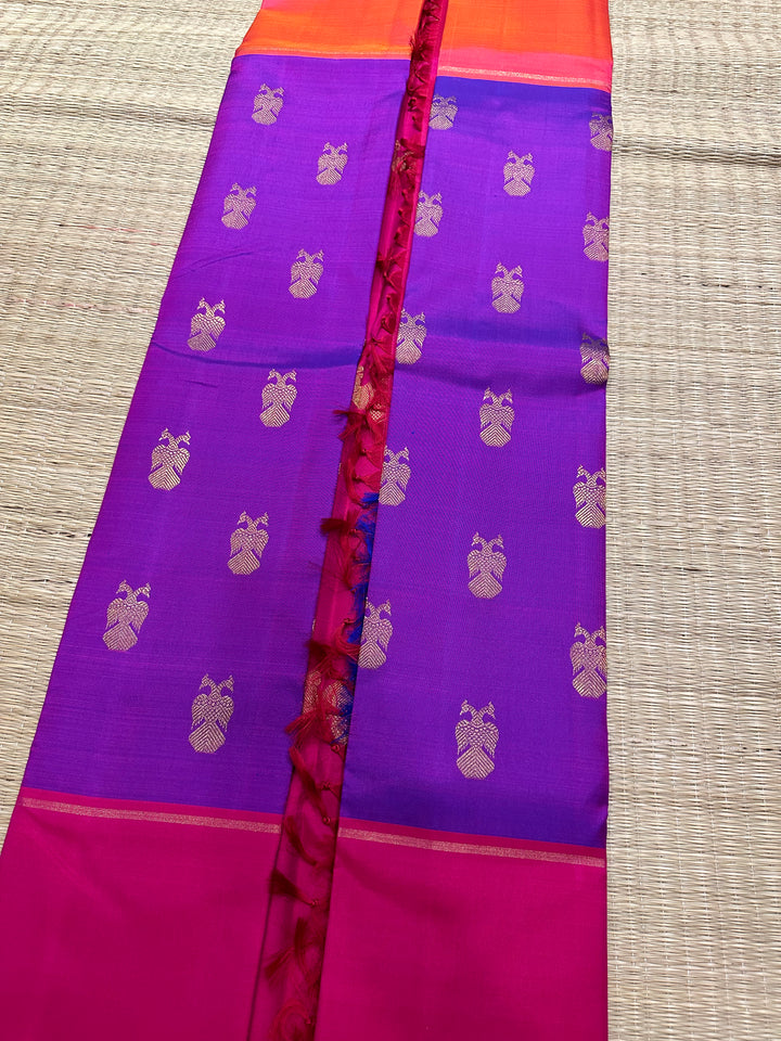 A Classic Mubbagam in Purple Orange and Magenta Shade with the Gandaberundu Zari motif in the Body and Rich Kili Motif in the Pallu Pure Kanjivaram Silk Saree