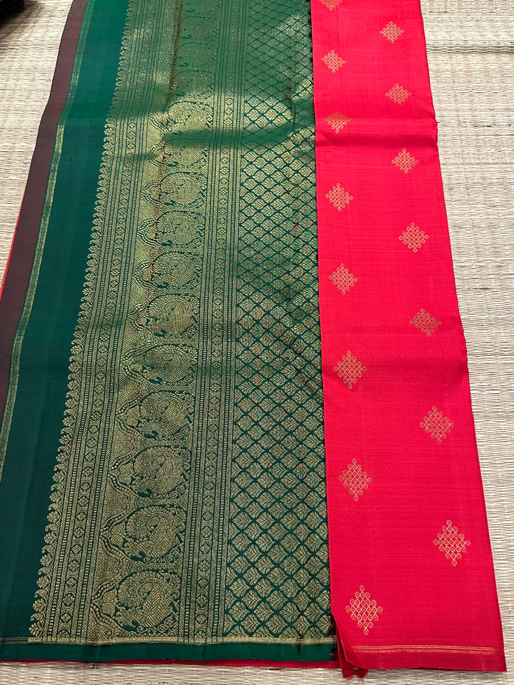 A Beautiful Red with Dark Green , Kolam Zari Motif in the Body and Rich Grand Pallu Pure Kanjivaram Silk Saree