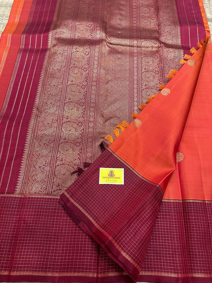 A Traditional Dark orange with Araku , Zari Checks Border , Mayil Chakram Zari Butta in Body and Traditional Rich Pallu Pure Kanjivaram Silk Saree