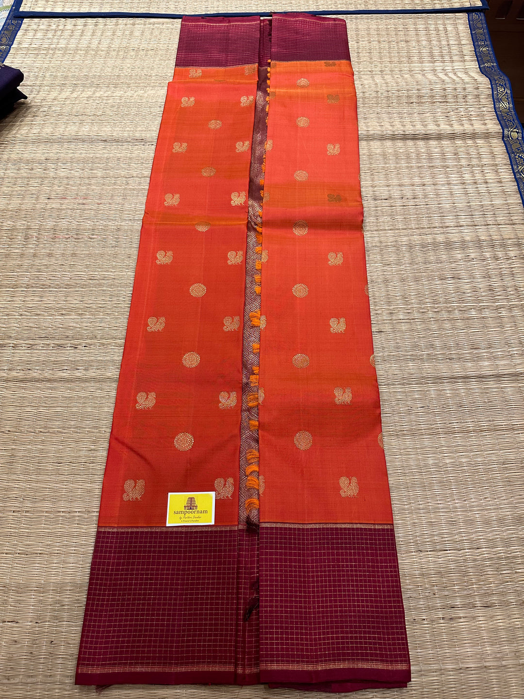 A Traditional Dark orange with Araku , Zari Checks Border , Mayil Chakram Zari Butta in Body and Traditional Rich Pallu Pure Kanjivaram Silk Saree