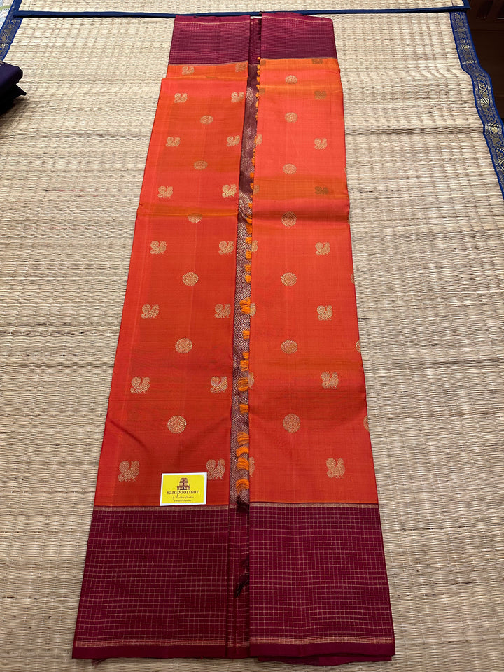 A Traditional Dark orange with Araku , Zari Checks Border , Mayil Chakram Zari Butta in Body and Traditional Rich Pallu Pure Kanjivaram Silk Saree