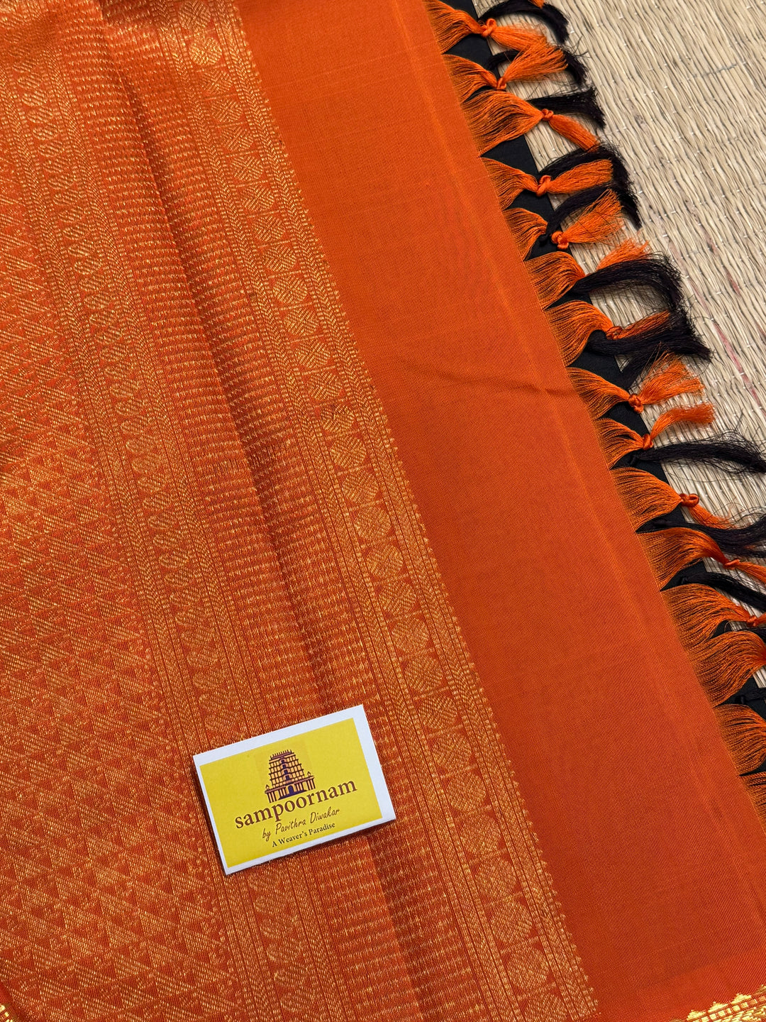 A classic Dark Podi Brown Colour with Fanta Orange Gomatha Cow and Calf Zari Motifs in the Body and Tradition Borders and Rich Pallu Pure Kanjivaram Silk Saree