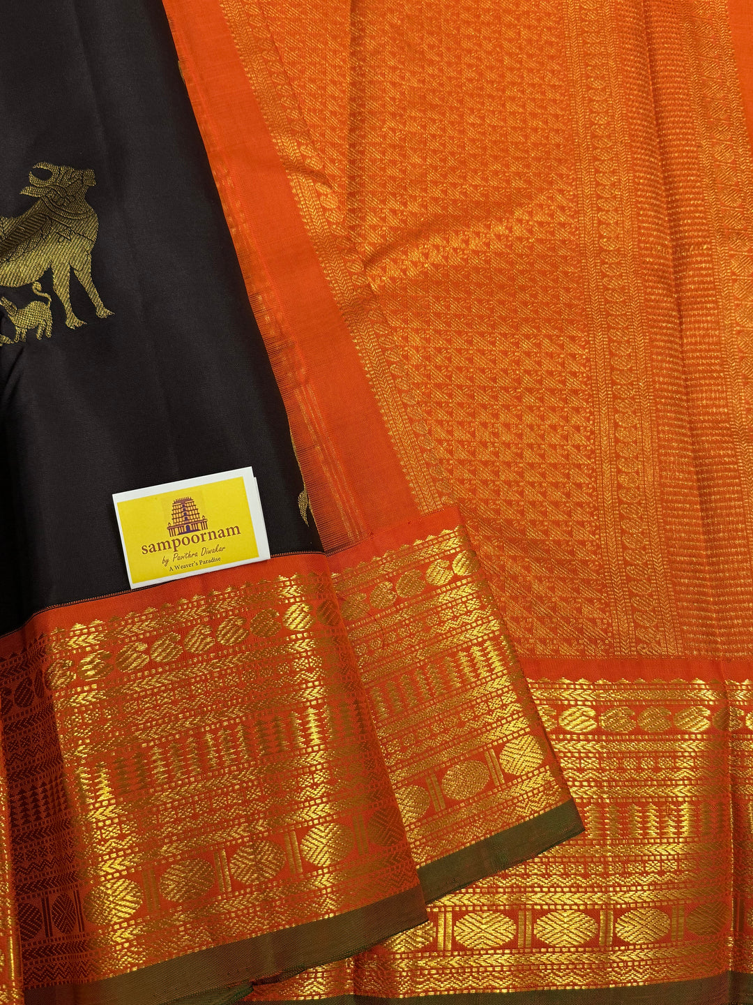 A classic Dark Podi Brown Colour with Fanta Orange Gomatha Cow and Calf Zari Motifs in the Body and Tradition Borders and Rich Pallu Pure Kanjivaram Silk Saree