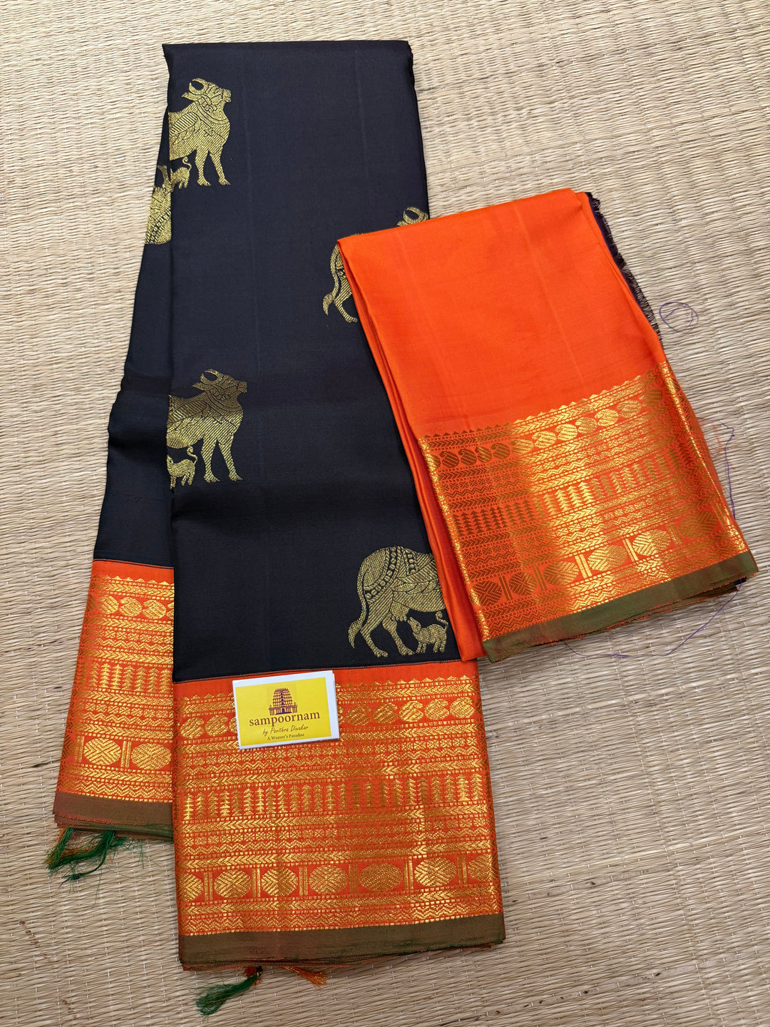 A classic Dark Podi Brown Colour with Fanta Orange Gomatha Cow and Calf Zari Motifs in the Body and Tradition Borders and Rich Pallu Pure Kanjivaram Silk Saree