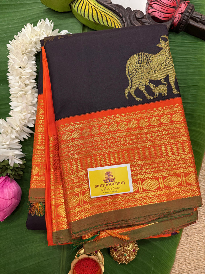 A classic Dark Podi Brown Colour with Fanta Orange Gomatha Cow and Calf Zari Motifs in the Body and Tradition Borders and Rich Pallu Pure Kanjivaram Silk Saree