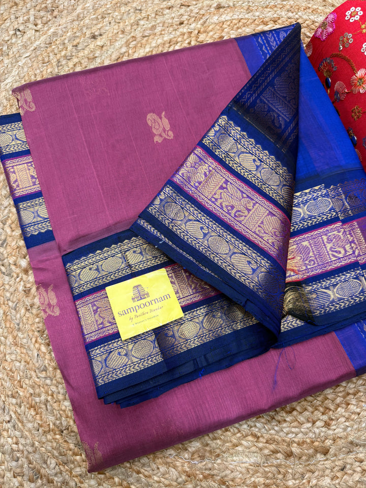 Mauve with Blue , rich Zari Mango  butta in the body , Traditional Kanchi borders and  rich Pallu Silk Cotton Saree