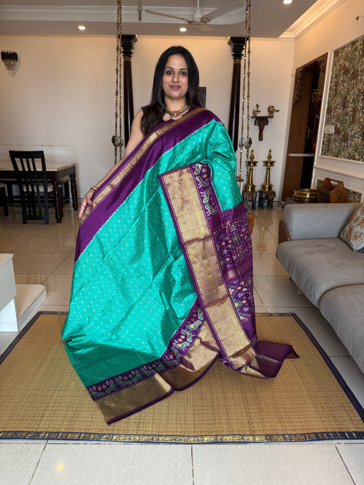 Turquoise Blue with Purple , checks in the body , design the blouse , traditional Kanchi borders and rich Pallu Pochampally Ikkat Silk Saree