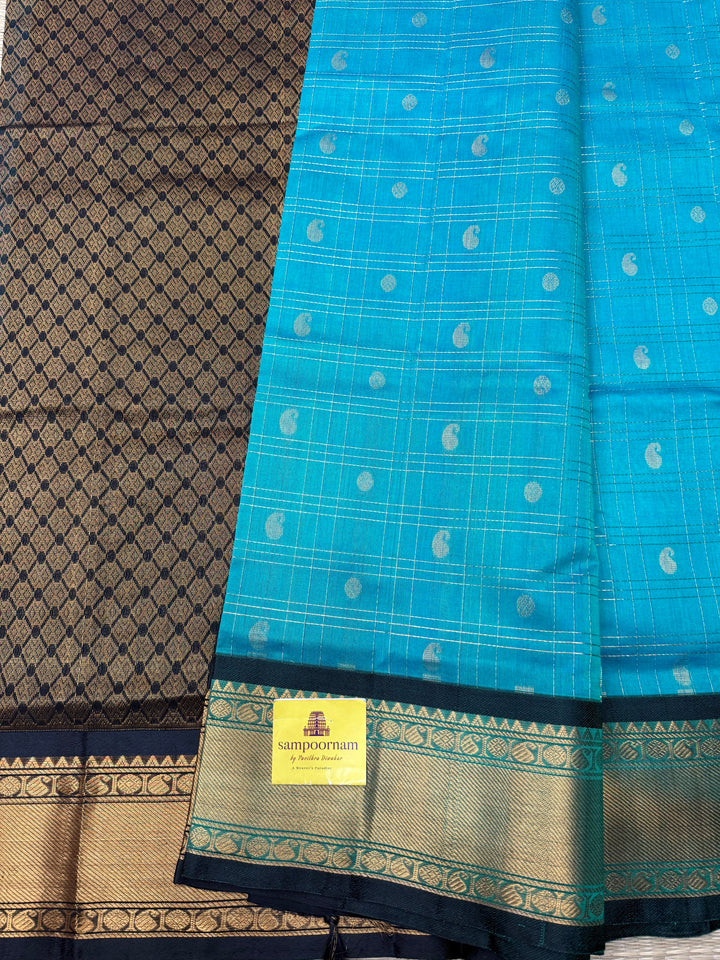 Teel Blue with Black , Zari Checks with Chakram and Mayil butta in the body , Traditional borders and  rich Pallu Silk Cotton Saree