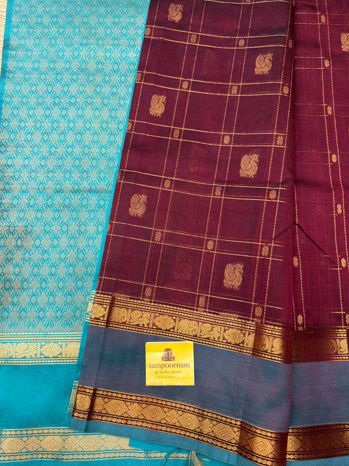 Arakku with Turquoise  , Zari Checks with Chakram and Mayil butta in the body , Traditional borders and  rich Pallu Silk Cotton Saree