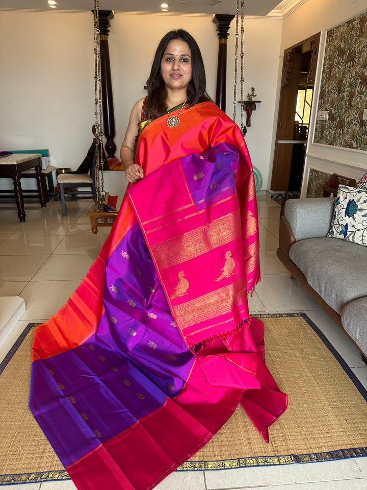 A Classic Mubbagam in Purple Orange and Magenta Shade with the Gandaberundu Zari motif in the Body and Rich Kili Motif in the Pallu Pure Kanjivaram Silk Saree