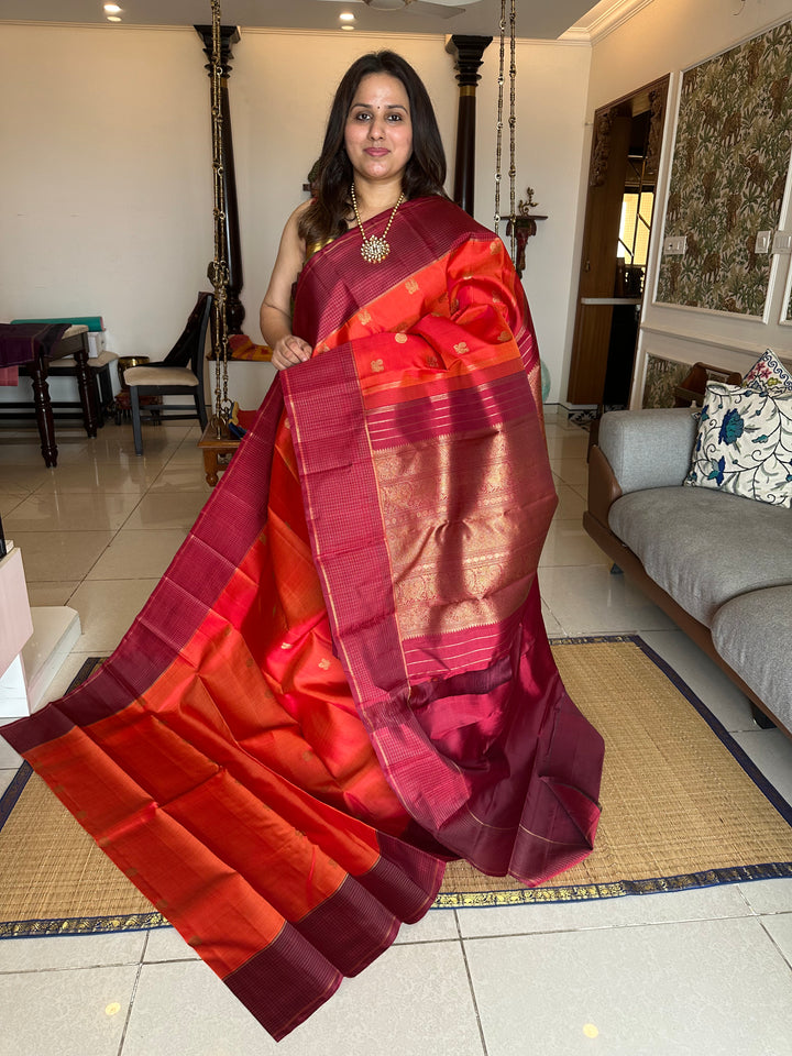 A Traditional Dark orange with Araku , Zari Checks Border , Mayil Chakram Zari Butta in Body and Traditional Rich Pallu Pure Kanjivaram Silk Saree