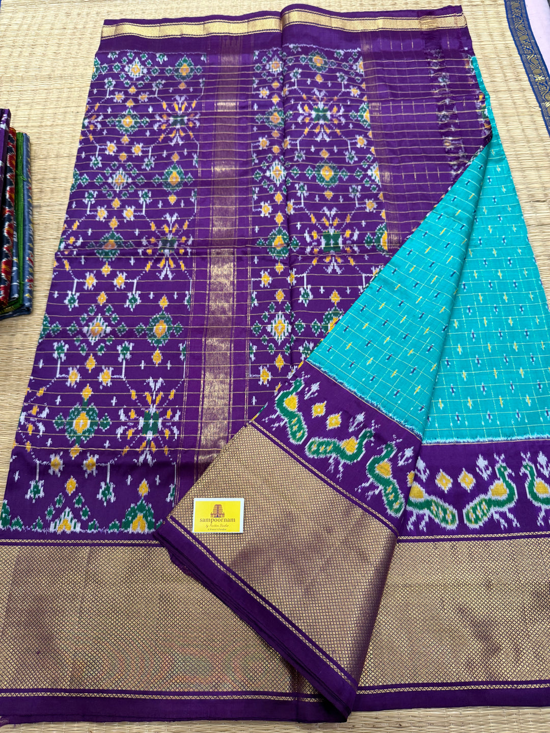 Turquoise Blue with Purple , checks in the body , design the blouse , traditional Kanchi borders and rich Pallu Pochampally Ikkat Silk Saree