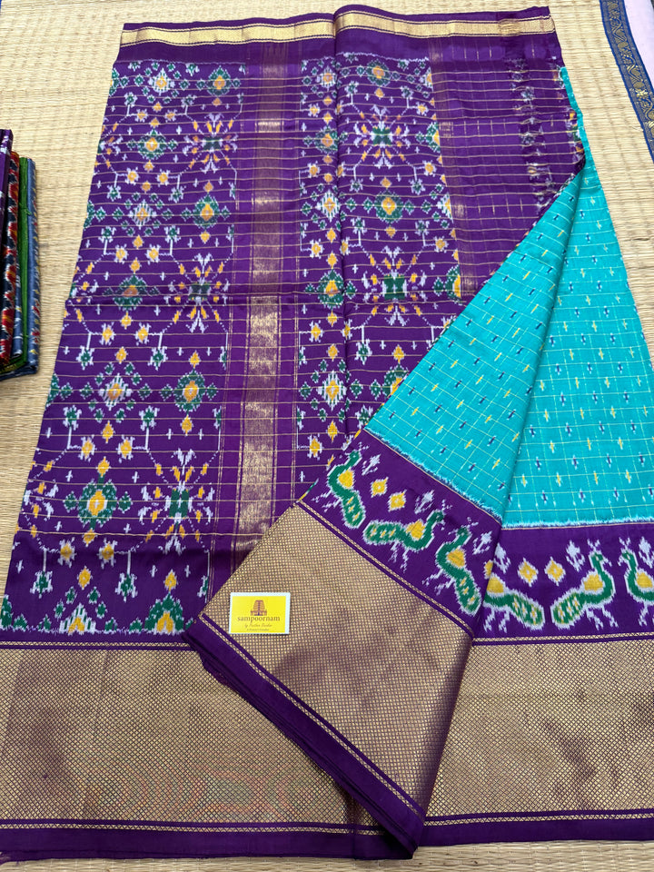 Turquoise Blue with Purple , checks in the body , design the blouse , traditional Kanchi borders and rich Pallu Pochampally Ikkat Silk Saree