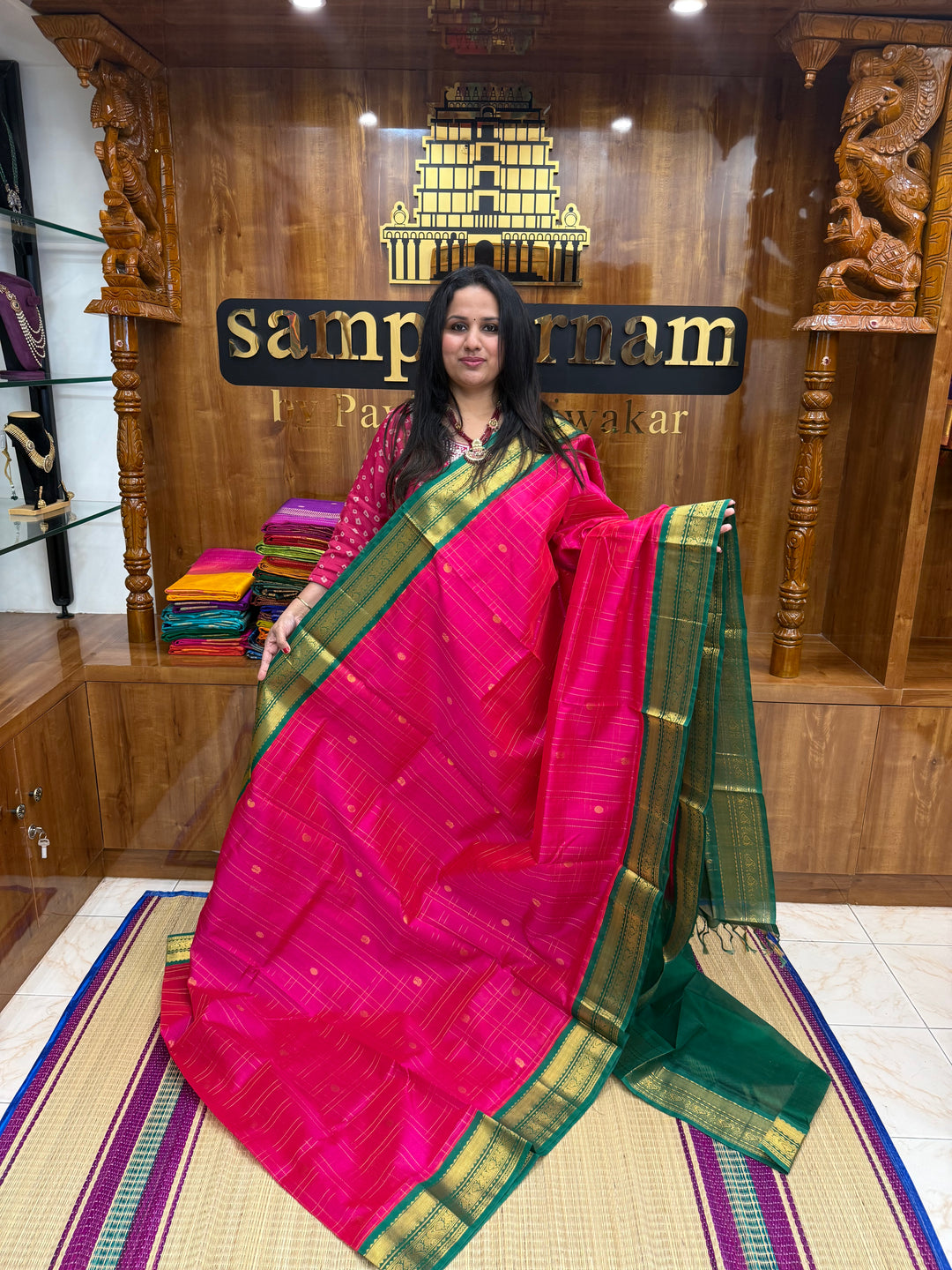 Pink with Green , rich Zari checks with Mayil Chakram butta in the body , rich Pallu Korvai Silk Cotton Saree