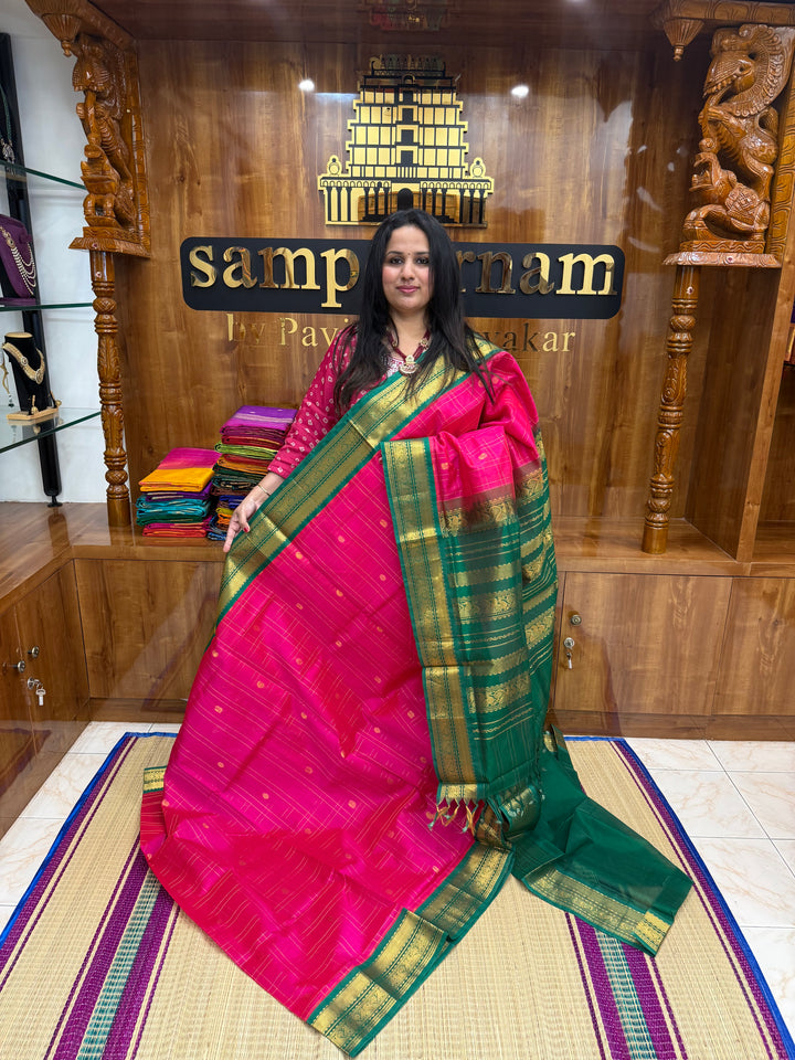 Pink with Green , rich Zari checks with Mayil Chakram butta in the body , rich Pallu Korvai Silk Cotton Saree
