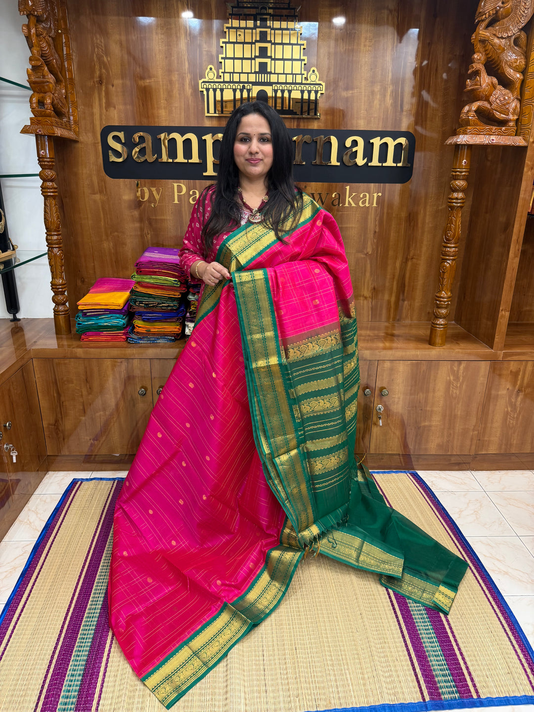 Pink with Green , rich Zari checks with Mayil Chakram butta in the body , rich Pallu Korvai Silk Cotton Saree