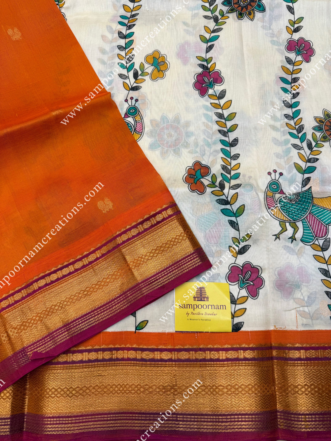 Offwhite with Orange  , Floral Madhubani  Prints all over the body , traditional borders and rich Pallu Korvai Silk Cotton Saree