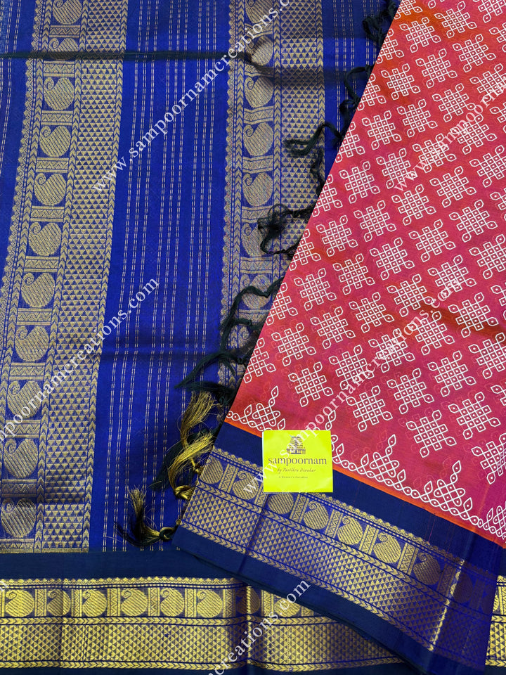 Orangish Pink with Dark Blue , Kolam Prints all over the body , traditional borders and rich Pallu Korvai Silk Cotton Saree