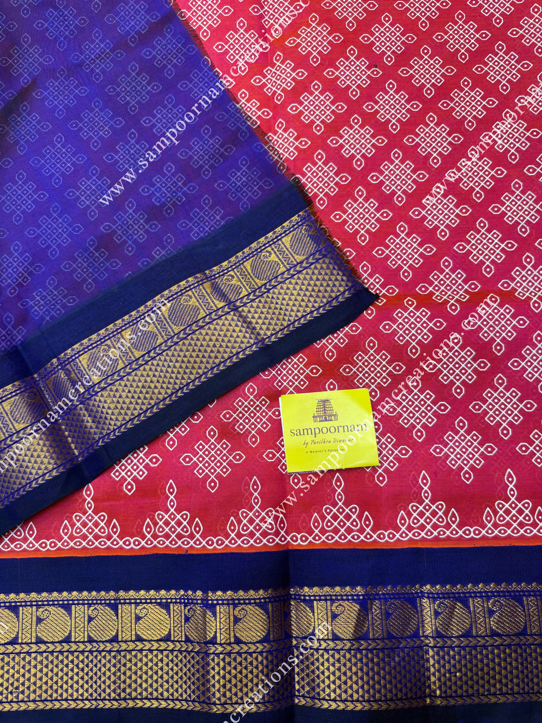 Orangish Pink with Dark Blue , Kolam Prints all over the body , traditional borders and rich Pallu Korvai Silk Cotton Saree