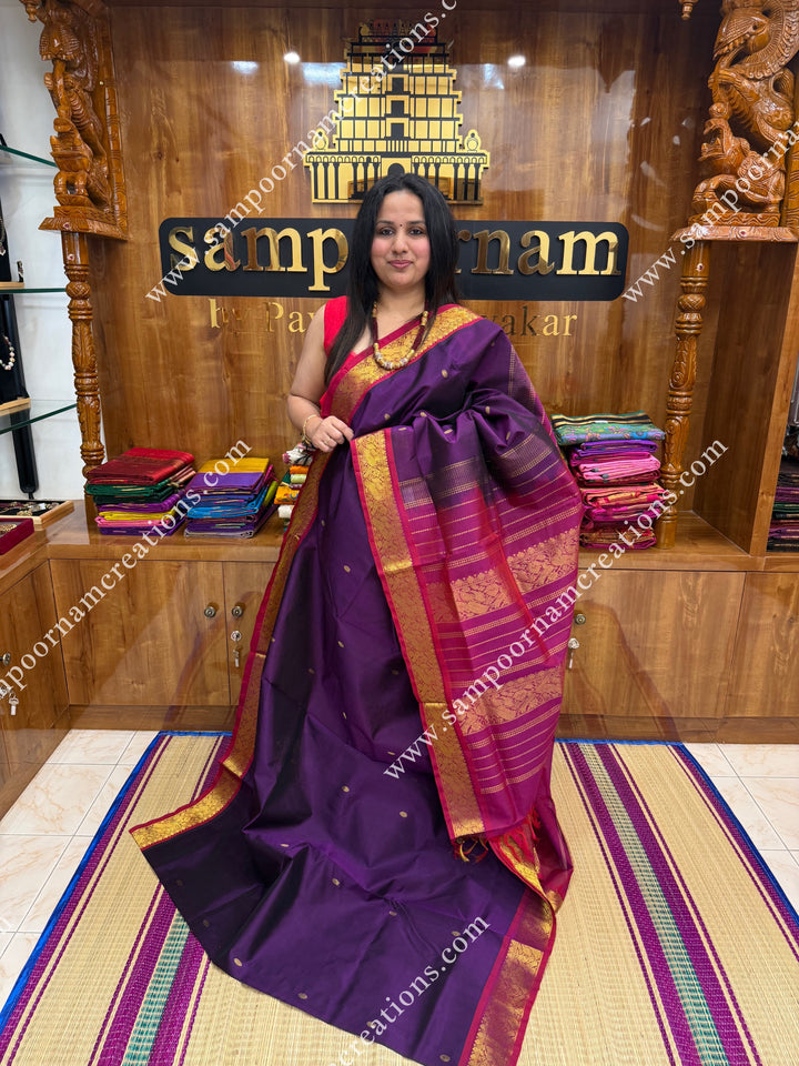 Wine with Magenta , Rich Zari Butta in the body , traditional borders and rich Pallu Silk Cotton Saree