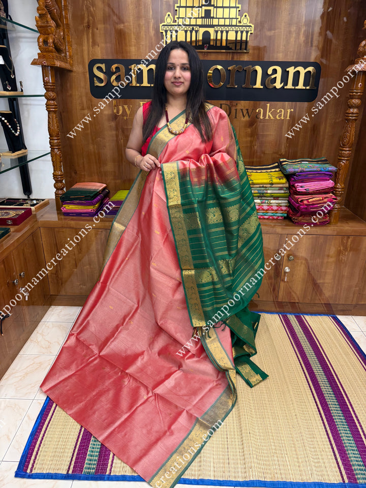Peach with Green  , Rich Zari Butta in the body , traditional borders and rich Pallu Silk Cotton Saree