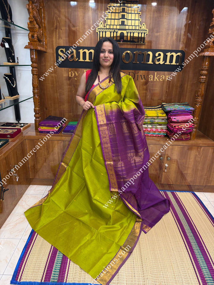 Lemon Yellow with Dark Magenta  , Rich Zari Butta in the body , traditional borders and rich Pallu Silk Cotton Saree