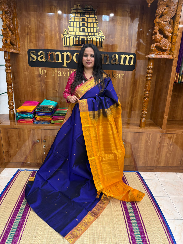 Ms Blue with Mustard , rich Zari butta in the body , Traditional Big Borders and rich Pallu  Silk Cotton Saree