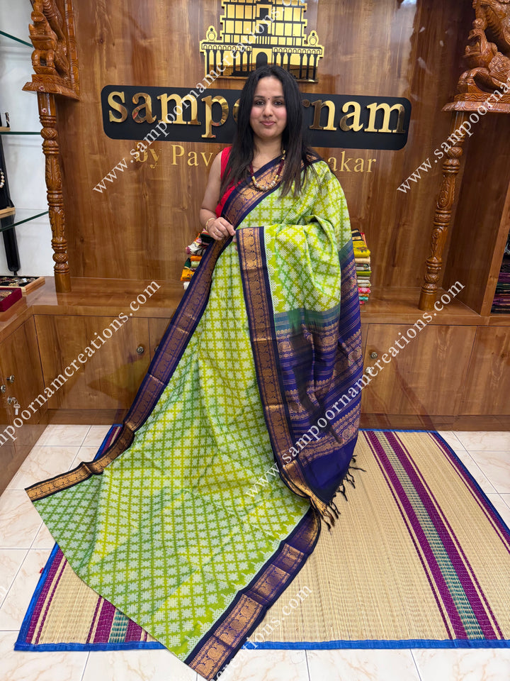 Parrot Green with Dark Blue , Kolam Prints all over the body , traditional borders and rich Pallu Korvai Silk Cotton Saree