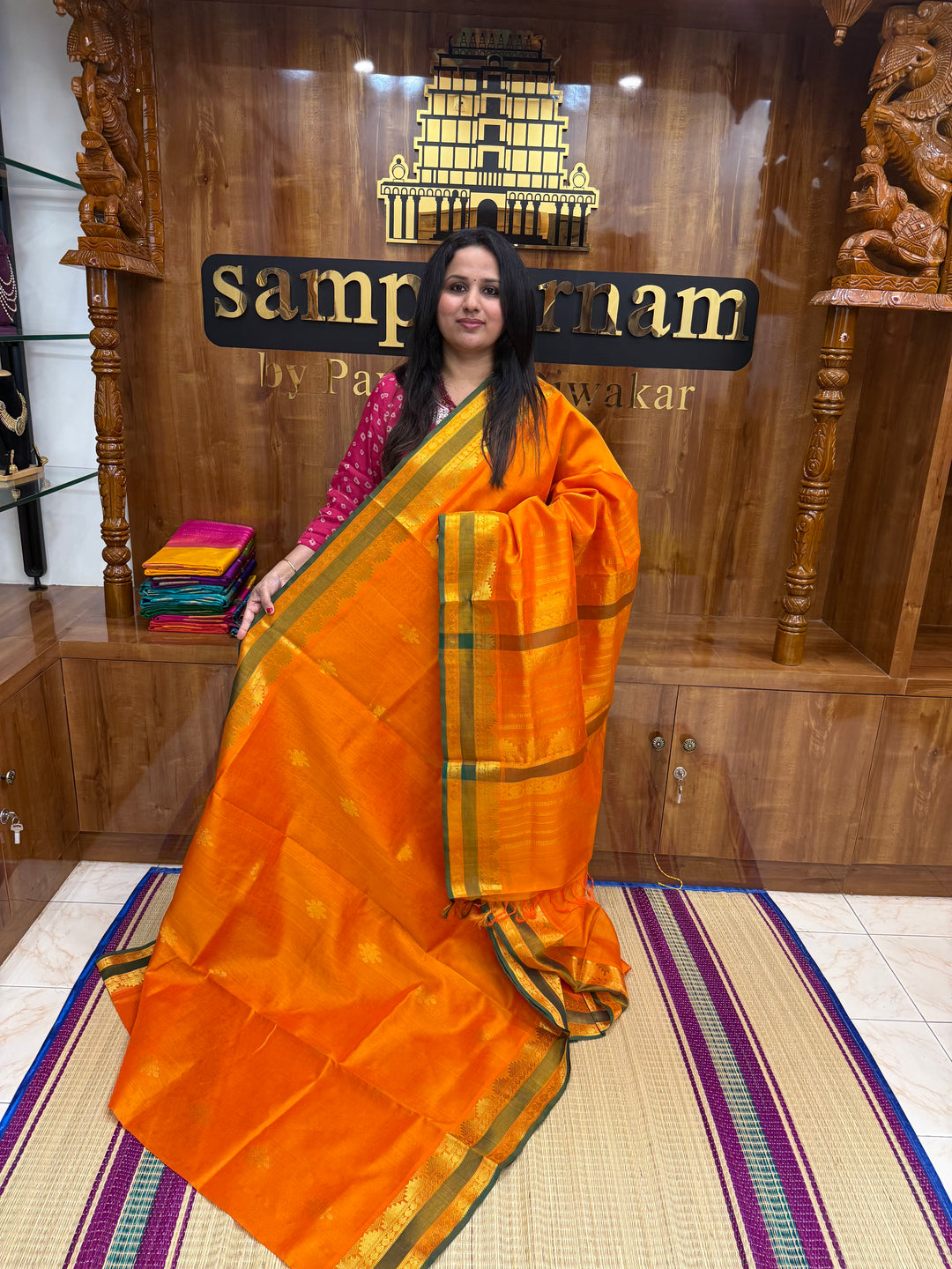Orange with Green Selvedge , rich Kolam Zari butta in the body , Rettapet borders and rich Pallu Silk Cotton Saree