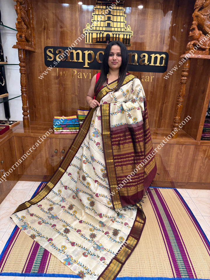 Off White with Wine, Floral Madhubani  Prints all over the body , traditional borders and rich Pallu Korvai Silk Cotton Saree