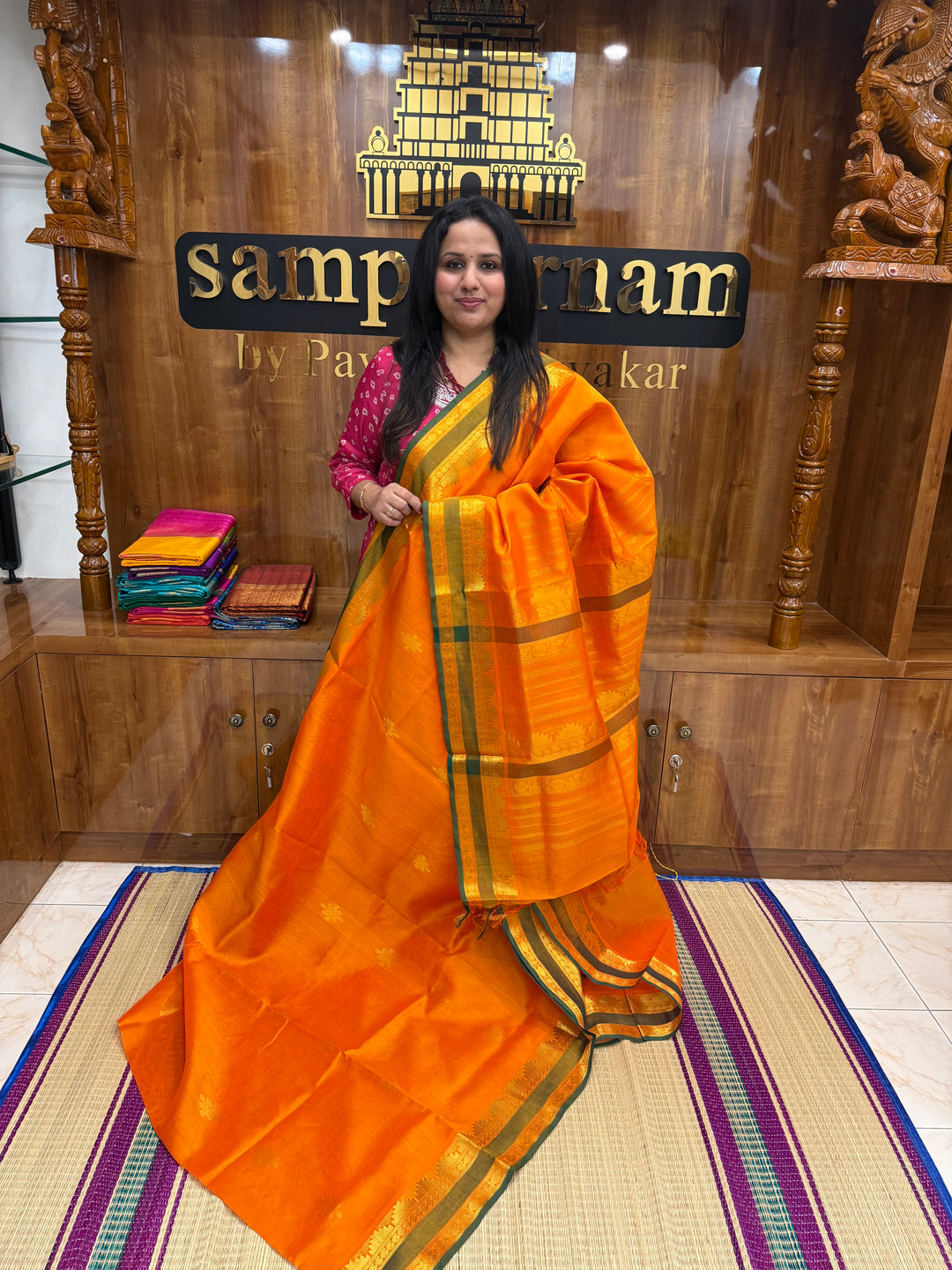 Orange with Green Selvedge , rich Kolam Zari butta in the body , Rettapet borders and rich Pallu Silk Cotton Saree