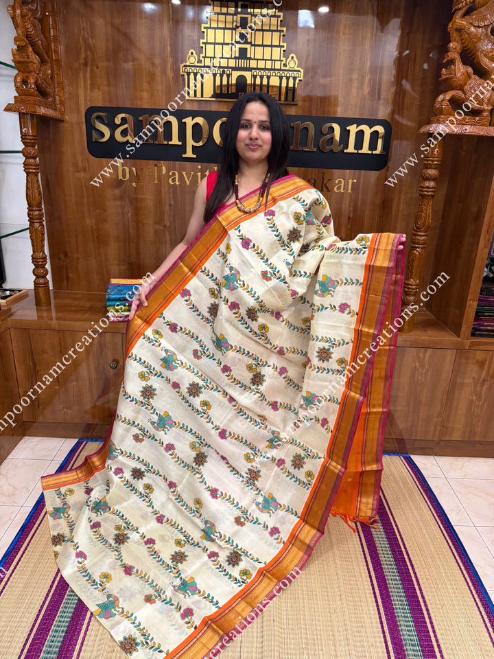 Offwhite with Orange  , Floral Madhubani  Prints all over the body , traditional borders and rich Pallu Korvai Silk Cotton Saree