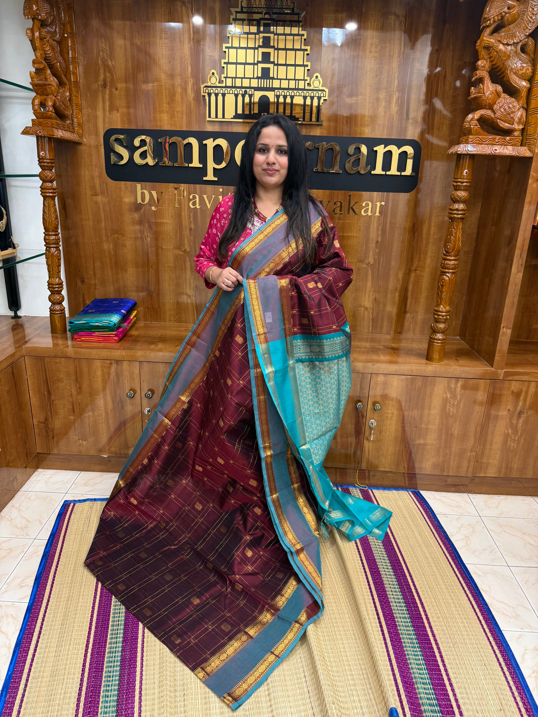 Arakku with Turquoise  , Zari Checks with Chakram and Mayil butta in the body , Traditional borders and  rich Pallu Silk Cotton Saree