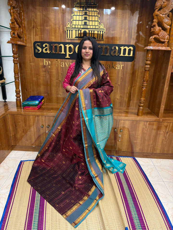 Arakku with Turquoise  , Zari Checks with Chakram and Mayil butta in the body , Traditional borders and  rich Pallu Silk Cotton Saree