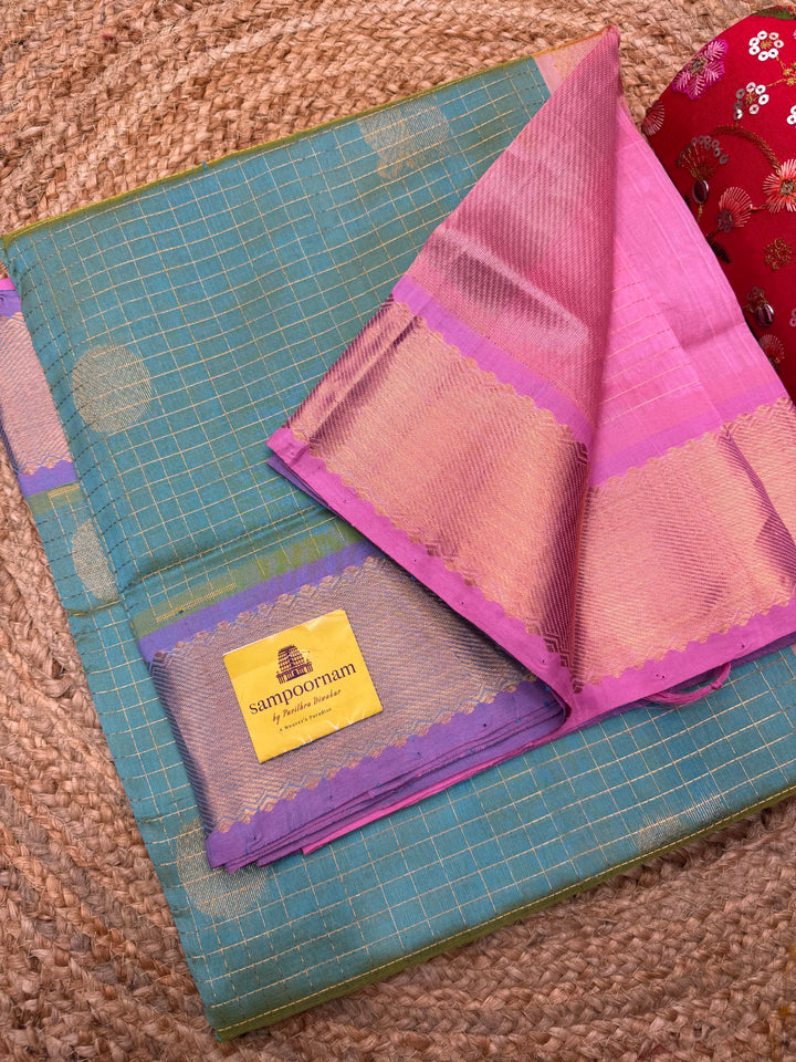 Double Shaded Sea Green with Baby Pink  , rich Zari checks with Mayil Chakram butta in the body , traditional borders and rich Pallu Korvai Silk Cotton Saree