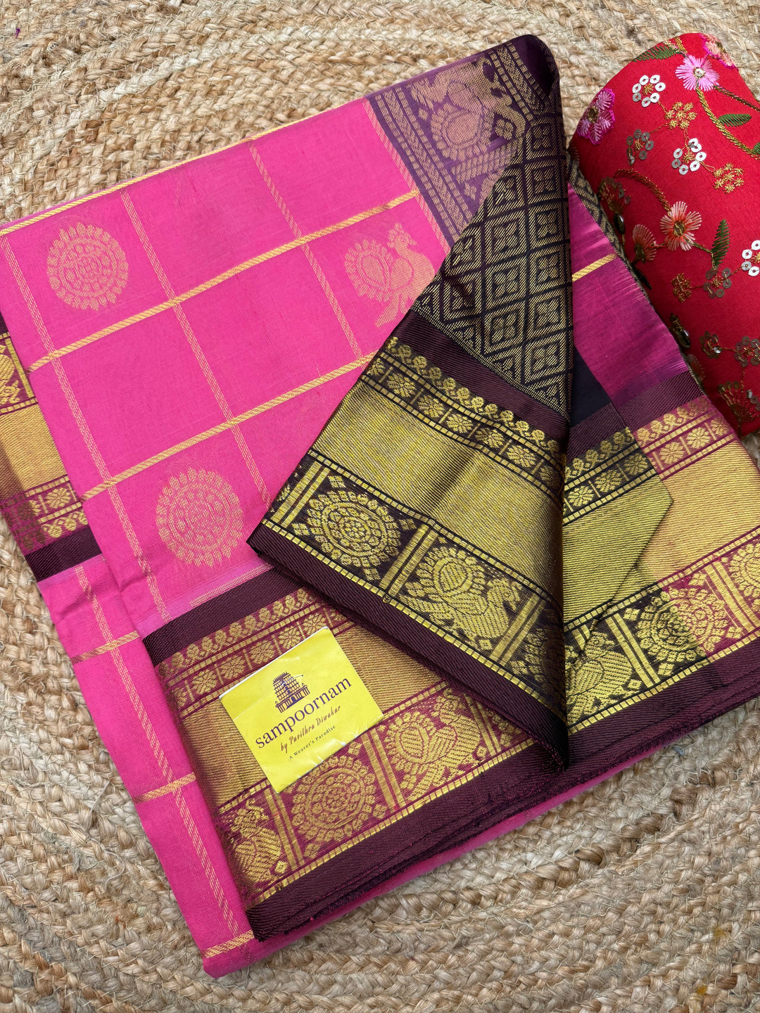 Baby Pink with Brown  , rich Zari checks with Mayil Chakram butta in the body , traditional borders and  rich Pallu Korvai Silk Cotton Saree
